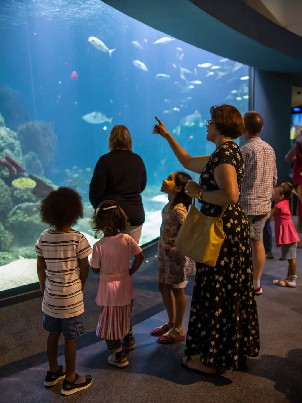 A photo of children participating in an educational workshop about aquatic life, learning about different fish species and the importance of conservation.